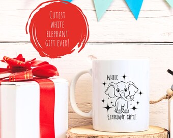 May include: White ceramic mug with a black and white illustration of a cartoon elephant with the text "White Elephant Gift!" on a white background.