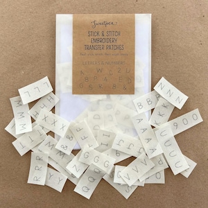 May include: A selection of Sweetpea Stick & Stitch Embroidery Transfer Patches. The pack contains letters, numbers, and symbols. The patches are white with black lettering, designed to be peeled, stuck, stitched, and then washed away.