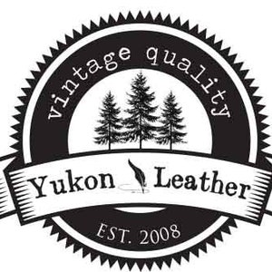 May include: Black and white logo with a vintage quality design. The logo features a circle with the text "vintage quality" around the edge. Inside the circle are three pine trees and the text "Yukon Leather" with a feather and inkwell design. Below the circle is the text "EST. 2008".