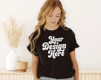 May include: A black t-shirt with the text "Your Design Here" in a retro font.