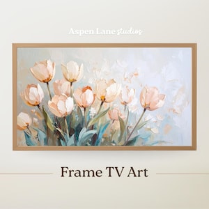 Puede incluir: Pintura floral enmarcada con tulipanes melocotón y blancos sobre un fondo azul claro y blanco. La obra de arte está en un marco de madera marrón claro. El texto "Aspen Lane studios" está en la parte superior y "Frame TV Art" en la parte inferior.