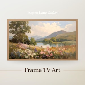 Puede incluir: Pintura de paisaje enmarcada que representa una serena escena lacustre con montañas al fondo. La obra de arte muestra un prado vibrante de flores silvestres en tonos rosas, blancos y morados. El texto "Aspen Lane studios" y "Frame TV Art" son visibles.