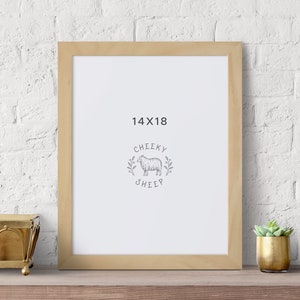 May include: A natural wood frame with a white mat and a white background. The frame is 14x18 inches and has the text "Cheeky Sheep" in the center.