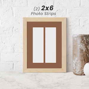 May include: A natural wood picture frame with two 2x6 photo strips. The frame has a brown mat and is ready to display your favorite photos.