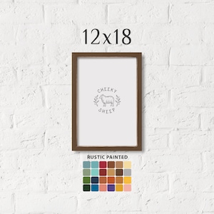 May include: A rustic brown wood frame with a white mat and a black and white illustration of a sheep with the text "Cheeky Sheep". The frame is 12 inches by 18 inches. A color palette of 36 colors is shown below the frame.