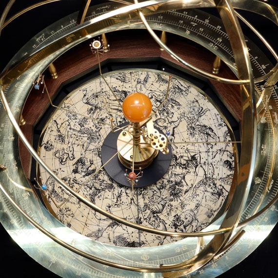 Close up gallery size Grand Orrery: 2 foot span. Shows semi-precious stone planets and Sun orrery, Flamsteed star atlas plate and solid brass gears, armillary and calendar ring. Copyright Nova Art LLC