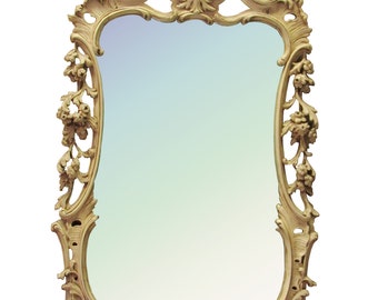 May include: A large, ornate, gold-colored mirror with a decorative, carved frame. The frame has a floral design with intricate details.
