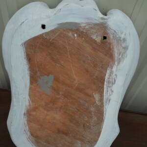 May include: White painted wooden plaque with a scalloped edge and two holes for hanging. The back of the plaque is made of wood and has a natural finish.