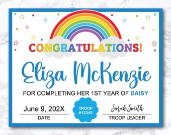 May include: A colorful rainbow certificate with white clouds and stars. The text reads "Congratulations! Eliza McKenzie for completing her 1st year of Daisy. June 9, 202X. Troop #12345. Sarah Smith Troop Leader. Planner Boutique."