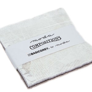 May include: A pack of fabric squares with a white background and a subtle gray pattern. The fabric is labeled "moda COMPOSITIONS BASICGREY for moda".