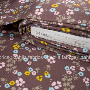 May include: Brown fabric with a small floral print in pink, blue, yellow, and gray. The fabric is folded and the label reads "CLOUD91 FABRICS" and "KNITS PATTERN 1397".