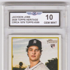 May include: A baseball card featuring Jackson Jobe of the Tigers, graded as Gem Mint. The card is from the 2025 Topps Heritage series, circa 1976. The card is encased in a protective holder with the number 10 visible.