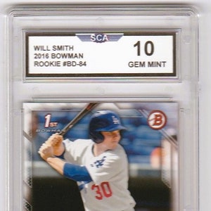 May include: A baseball card featuring Will Smith, a rookie player for the Los Angeles Dodgers. The card is graded Gem Mint 10 by the Sportscard Guaranty Corporation (SGC). The card shows Smith in a batting stance, wearing a white jersey with the number 30, a blue cap, and a blue and white baseball uniform. The card is from the 2016 Bowman baseball card set.