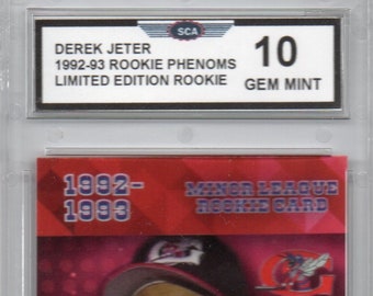 May include: A red and blue baseball card featuring Derek Jeter, a New York Yankees shortstop. The card is from the 1992-1993 Rookie Phenoms series and is a limited edition ruby card.