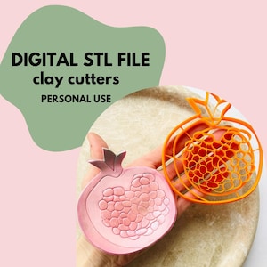 May include: A pink and orange pomegranate-shaped clay cutter set. The pink cutter is a solid shape, while the orange cutter is a wireframe design. The image includes the text "DIGITAL STL FILE clay cutters PERSONAL USE".