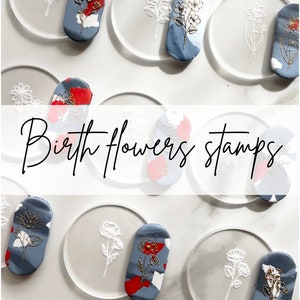 May include: Birth flower stamps with floral designs on clear acrylic stamps and blue and red clay stamps. The clay stamps have gold accents.