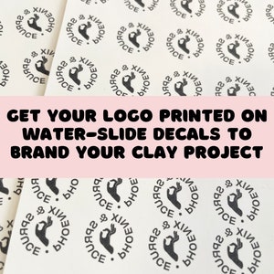 May include: Close-up of a sheet of white water-slide decals with a black and white logo that says "PHOENIX" and features a hand making the "OK" sign. The text "GET YOUR LOGO PRINTED ON WATER-SLIDE DECALS TO BRAND YOUR CLAY PROJECT" is printed in pink at the top of the image.
