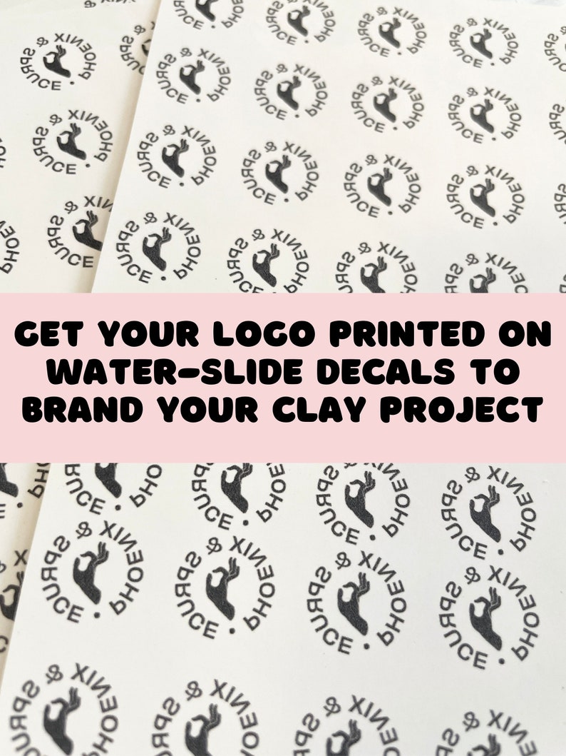 May include: Close-up of a sheet of white water-slide decals with a black and white logo that says "PHOENIX" and features a hand making the "OK" sign. The text "GET YOUR LOGO PRINTED ON WATER-SLIDE DECALS TO BRAND YOUR CLAY PROJECT" is printed in pink at the top of the image.