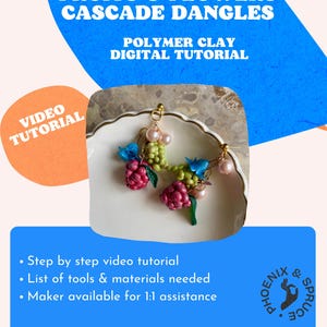 May include: A pair of handmade polymer clay earrings with a cascade design featuring miniature fruits and flowers. The earrings are displayed on a white plate and include pink, red, green, and blue accents. The image also includes text that says "Fruits & Flowers Cascade Dangles".