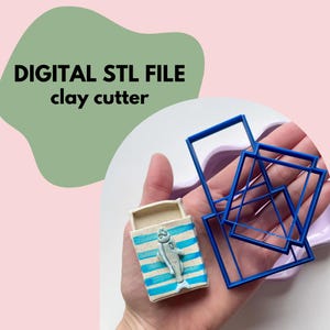 May include: The image shows a digital STL file for a clay cutter. The image includes a blue and white striped ceramic matchbox with a fish design, and several blue square clay cutters. The text "DIGITAL STL FILE clay cutter" is in the upper left corner.