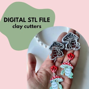 May include: The image displays clay cutters and finished clay earrings. The cutters are mushroom-shaped with a detailed design. The earrings feature a red and white mushroom cap, a green face, and a red stem. The text "DIGITAL STL FILE clay cutters" is visible.