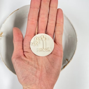 Photo of a clay stamp for polymer clay earrings and jewelry, representing an orchid flower.