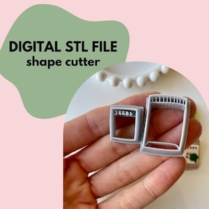 May include: A digital STL file for a 3D printed shape cutter. The cutter is grey and has a rectangular shape with a smaller square cutout. The text "SEGGS" is visible on the smaller cutout.