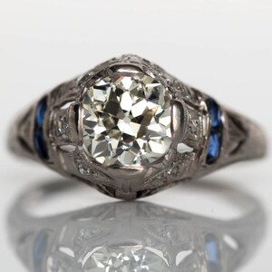 Circa 1920s Art Deco Platinum 1.09ct Old European Cut Diamond Engagement Ring with .08cttw Sapphires & Side Stones - VEG#716