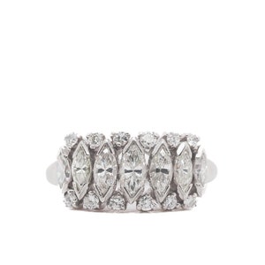 May include: A silver ring with a row of marquise-shaped diamonds set in a band.