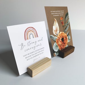 May include: Two inspirational cards with a rainbow and floral design. The text on the cards reads "Be strong and courageous. Don't be fearful or discouraged because the Lord your God is with you wherever you go. Joshua 1:9" and "My grace is sufficient for you, for my power is made perfect in weakness. 2 Cor 12:9".