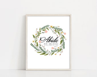 May include: A white framed print with a floral wreath and the text "Abide in me, and I in you John 15:4".