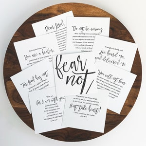 May include: A set of eight white cards with black text. Each card features a different inspirational quote from the Bible. The quotes include "Fear not, for I am with you", "Do not be anxious", "For God has not given us a spirit of fear", "You will not fear the terror of night", "I sought the Lord, and He heard me, and delivered me", "Dear Lord, I know that you are a healer", "Dear Lord, I know that you are a healer", and "But take heart! I have overcome the world."