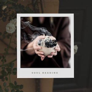 May include: A person holds a small ceramic bowl with smoldering incense, creating wispy smoke. The bowl is decorated with a dark glaze and has a rough texture. The text "SOUL READING" is printed below the image.