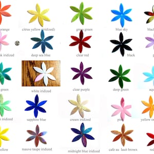 May include: Assortment of 25 glass flower tiles in various colors and finishes, including clear, iridescent, and solid colors. The tiles are arranged in five rows of five tiles each.