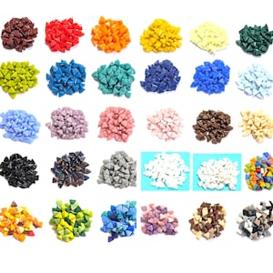 May include: A collection of small, triangular mosaic tiles arranged in thirty separate piles, each featuring a distinct solid color or a multi-colored mix, including shades of red, blue, green, yellow, brown, black, white, and various pastels.