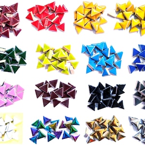 May include: A collection of small triangular ceramic tiles arranged in sixteen distinct color groups, including shades of red, yellow, green, blue, pink, purple, black, gray, white, metallic gold, and iridescent finishes with glossy surfaces.