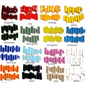 May include: A collection of rectangular ceramic tiles arranged in twenty distinct color groups, each labeled with its corresponding color name including burgundy, red, orange, yellow, dark green, moss green, lime green, turquoise, dark blue, pale blue, purple, pale pink, brown, black, gray, and white.