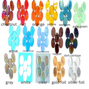 May include: A collection of oval-shaped glass cabochons arranged in groups by color, labeled as chestnut, red, orange, yellow, seafoam, pale green, aqua, clear blue, moonstone, copper, dark rainbow, gray, white, clear, gold foil, and silver foil.