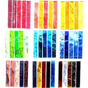 May include: A collection of rectangular glass strips arranged in a grid, featuring a wide spectrum of colors including red, orange, yellow, green, blue, purple, brown, black, and white, with varying textures and degrees of translucency.