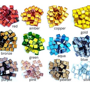 May include: Twelve clusters of small square glass mosaic tiles in various colors including red, amber, copper, gold, bronze, green, aqua, blue, purple, pink, pewter, and silver. Each color group is labeled with its corresponding name below it.