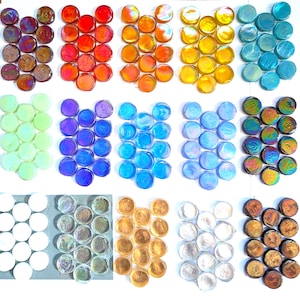 May include: A collection of circular glass cabochons arranged in fifteen distinct color groups. The set includes iridescent, translucent, and opaque finishes in shades of red, orange, yellow, blue, green, purple, white, and metallic bronze.