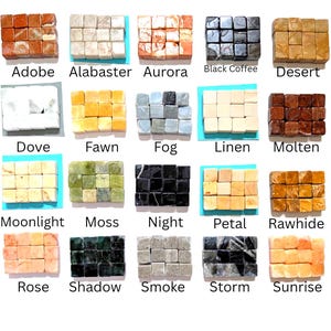 May include: A collection of twenty sets of small, square stone cubes arranged in grids, each labeled with names including Adobe, Alabaster, Aurora, Black Coffee, Desert, Dove, Fawn, Fog, Linen, Molten, Moonlight, Moss, Night, Petal, Rawhide, Rose, Shadow, Smoke, Storm, and Sunrise.