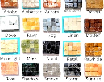 May include: A collection of twenty sets of small, square stone cubes arranged in grids, each labeled with names including Adobe, Alabaster, Aurora, Black Coffee, Desert, Dove, Fawn, Fog, Linen, Molten, Moonlight, Moss, Night, Petal, Rawhide, Rose, Shadow, Smoke, Storm, and Sunrise.