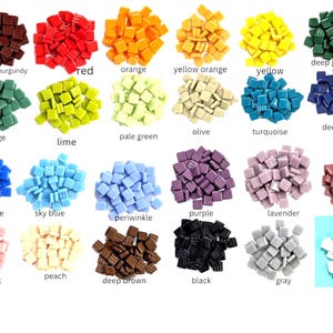 May include: A collection of small square glass mosaic tiles arranged in twenty-four distinct color groups, including burgundy, red, orange, yellow orange, yellow, deep green, sage, lime, pale green, olive, turquoise, deep blue, bright blue, sky blue, periwinkle, purple, lavender, deep pink, pale pink, peach, deep brown, black, gray, and white.