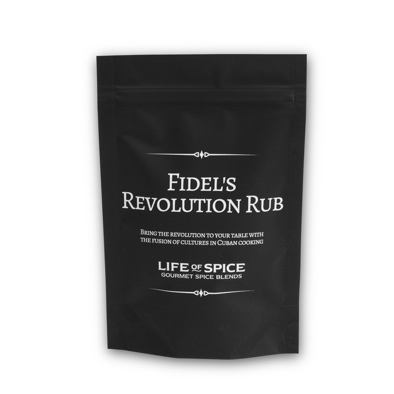 May include: Black pouch with white text that reads "FIDEL'S REVOLUTION RUB" and "BRING THE REVOLUTION TO YOUR TABLE WITH THE FUSION OF CULTURES IN CUBAN COOKING" and "LIFE OF SPICE GOURMET SPICE BLENDS".