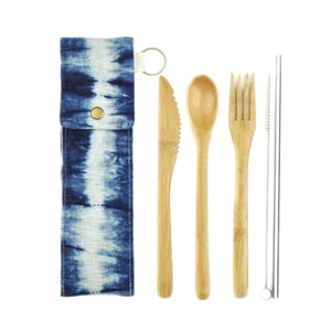 May include: A set of reusable bamboo cutlery and a stainless steel straw, all in a blue and white tie-dye fabric pouch. The set includes a knife, fork, spoon, and straw.