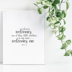 May include: A white framed print with a black and white quote from the Bible: "Whoever welcomes one of these little children in my name welcomes me." Mark 9:37.