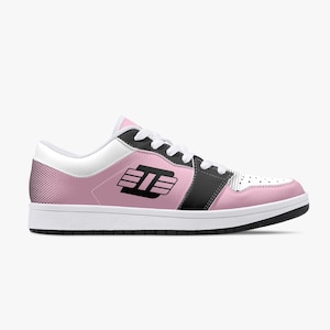 May include: A pair of pink and black low-top sneakers with a black and white logo on the side. The logo is a stylized letter "D" with three horizontal lines.