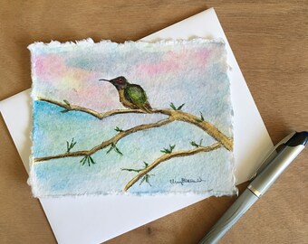 Hand-painted watercolor card of a hummingbird sits on a branch in the sunrise, approx. 4.5"x6". Mailable art, art card, custom painted.