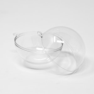 May include: Two clear, spherical, plastic ornaments with a loop at the top for hanging. One is open, revealing the interior, while the other is partially open. The ornaments are on a white background.